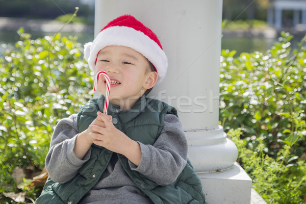 Cute Mixed Race Boy With Santa Hat and Candy Cane Stock photo © feverpitch