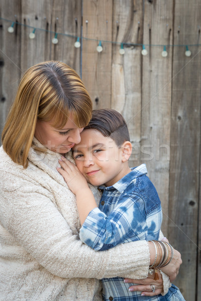 Mother and Mixed Race Son Hug Near Fence Stock photo © feverpitch