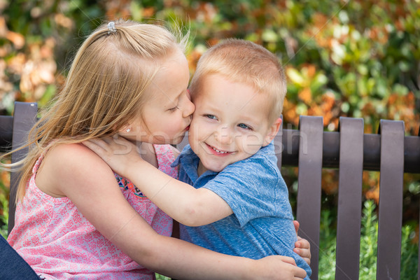 Stock photo: Young Sister and Brother Having Fun On The Bench At The Park