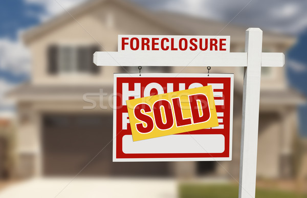 Sold Foreclosure Home For Sale Sign and House Stock photo © feverpitch