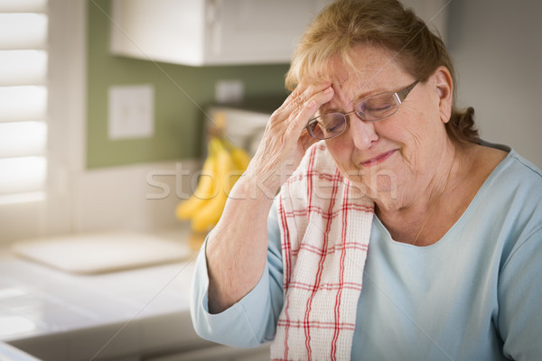 Sad Crying Senior Adult Woman At Kitchen Sink Stock photo © feverpitch