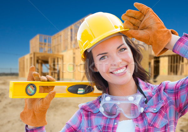 Female Construction Worker Holding Level Wearing Gloves, Hard Ha Stock photo © feverpitch