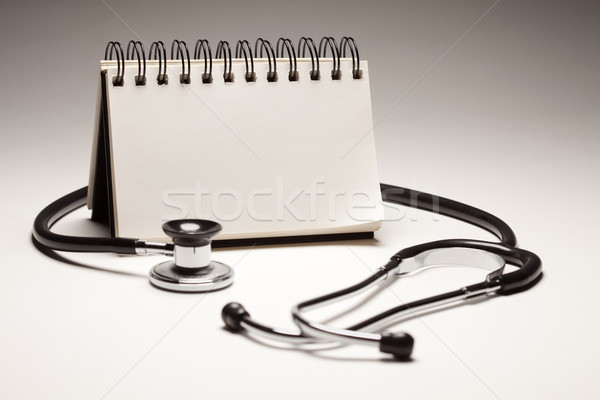 Blank Spiral Note Pad and Black Stethoscope Stock photo © feverpitch