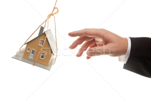 Swinging House and Business Man's Hand Reaching or Pushing Stock photo © feverpitch