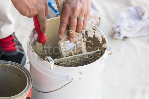 Professional Painter Loading Paint Onto Brush From Bucket Stock photo © feverpitch