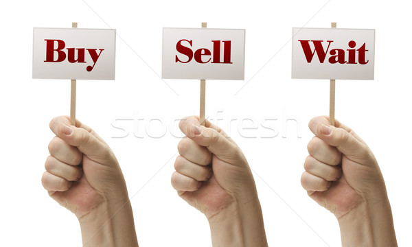 Stock photo: Three Signs In Fists Saying Buy, Sell and Wait