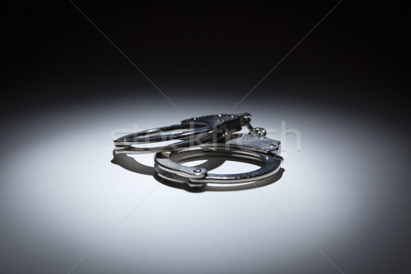 Abstract Pair of Handcuffs Under Spot Light Stock photo © feverpitch