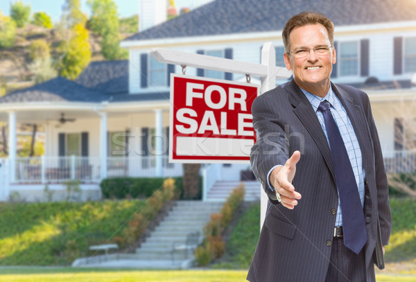 Male Agent Reaching for Hand Shake in Front of House and For Sal Stock photo © feverpitch