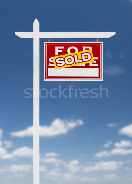 Right Facing Sold For Sale Real Estate Sign on a Blue Sky with C Stock photo © feverpitch