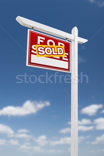 Left Facing Sold For Sale Real Estate Sign on a Blue Sky with Cl Stock photo © feverpitch