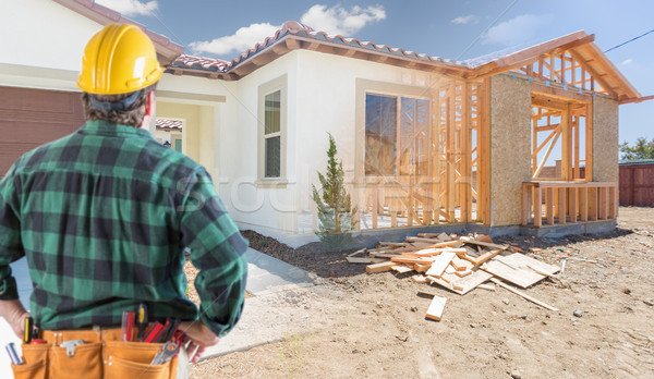 Contractor Standing Outside Construction Framing and Photo of Ne Stock photo © feverpitch