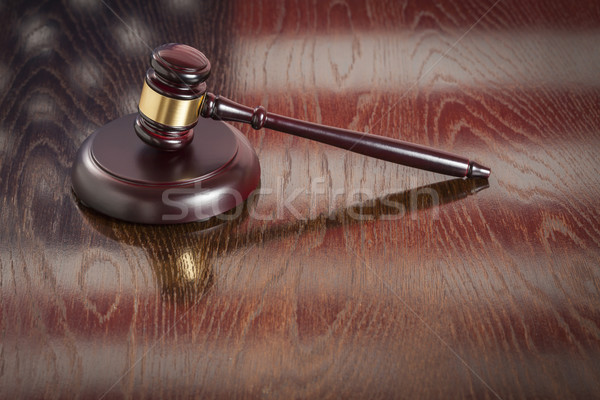 Wooden Gavel Resting on Flag Reflecting Table Stock photo © feverpitch