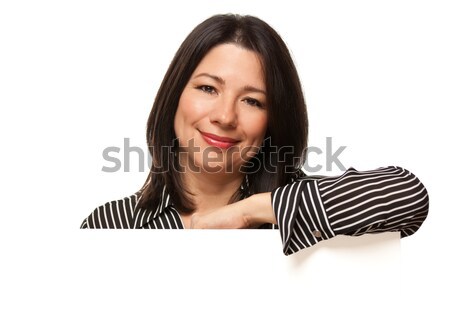 Attractive Multiethnic Woman Looking Down to Blank White Sign Stock photo © feverpitch
