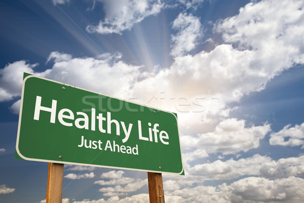 Healthy Life Green Road Sign Over Clouds Stock photo © feverpitch