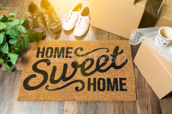 Home Sweet Home Welcome Mat, Moving Boxes, Women and Male Shoes  Stock photo © feverpitch