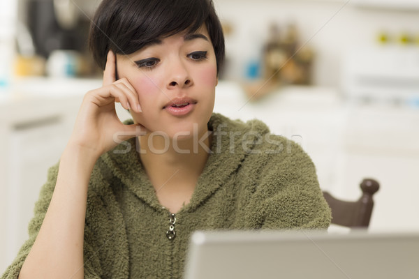 Pretty Mixed Race Woman Using Laptop at Home Stock photo © feverpitch
