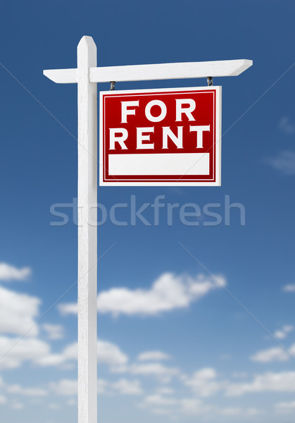 Stock photo: Right Facing For Rent Real Estate Sign on a Blue Sky with Clouds