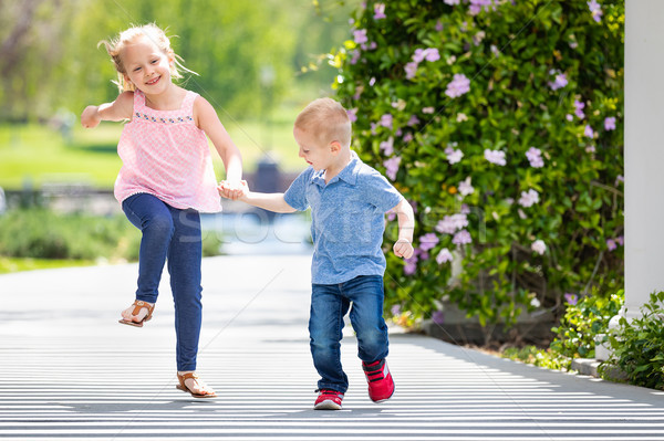 Stock photo: Young Sister and Brother Holding Hands And Running At The Park