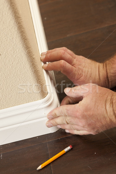 Contractor Installing New Baseboard with Bull Nose Corners and N Stock photo © feverpitch