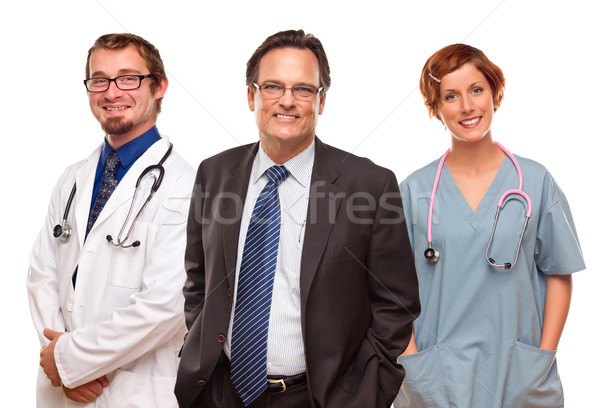 Smiling Businessman with Doctors and Nurses Stock photo © feverpitch