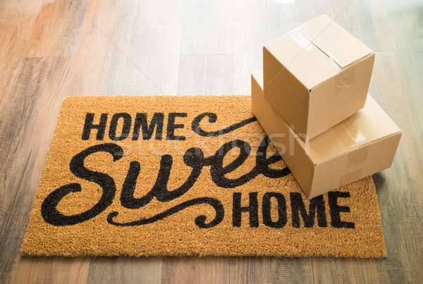 Home Sweet Home Welcome Mat On Wood Floor With Boxes Stock photo © feverpitch