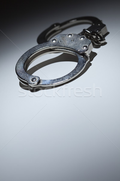 Abstract Pair of Handcuffs Under Spot Light - Text Room Stock photo © feverpitch