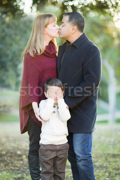 Mix Race Couple Kissing As Young Son Hides His Eyes Stock photo © feverpitch