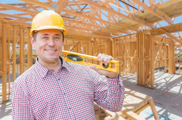 Contractor With Level On Site Inside New Home Construction Frami Stock photo © feverpitch