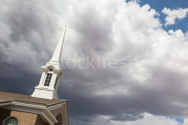 Church Steeple Tower Below Ominous Stormy Thunderstorm Clouds. Stock photo © feverpitch