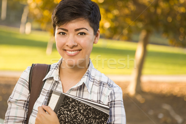 Portrait of a Pretty Mixed Race Female Student Holding Books Stock photo © feverpitch