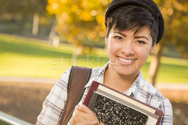 Portrait of a Pretty Mixed Race Female Student Holding Books Stock photo © feverpitch