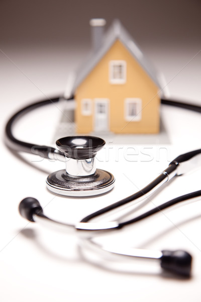 Stethoscope and Model House on Gradated Background Stock photo © feverpitch