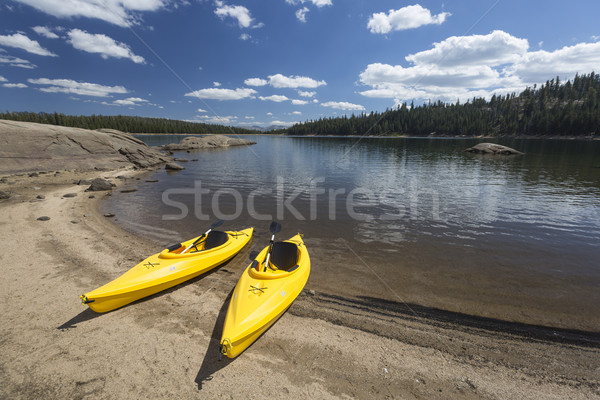 Pair of Yellow Kayaks on Beautiful Mountain Lake Shore. Stock photo © feverpitch