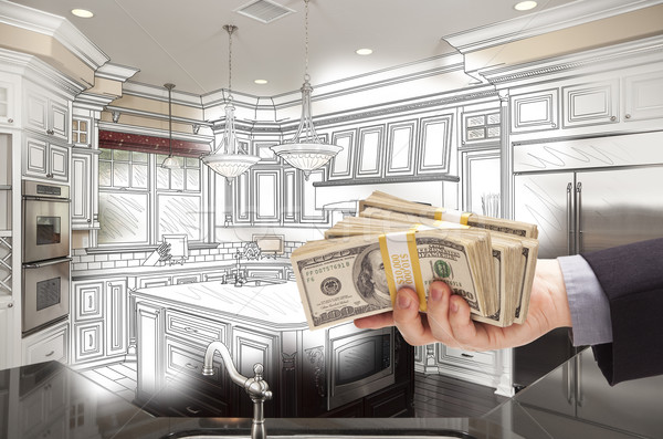 Hand Holding Cash Over Kitchen Design Drawing and Photo Combinat Stock photo © feverpitch