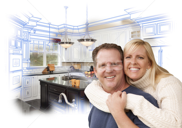 Happy Couple Hugging with Custom Kitchen Drawing and Photo Behin Stock photo © feverpitch