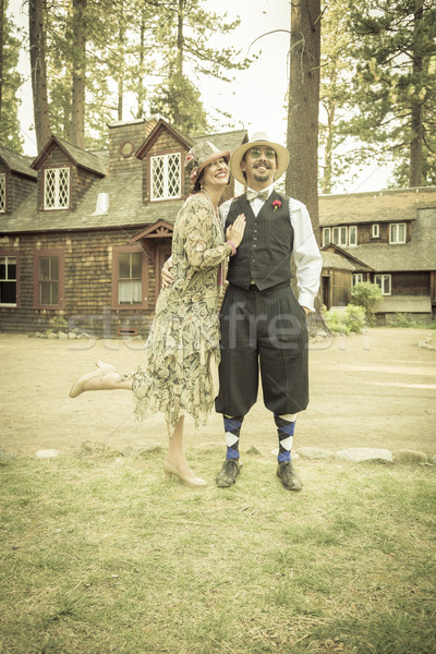 Stock photo: 1920s Dressed Romantic Couple in Front of Old Cabin