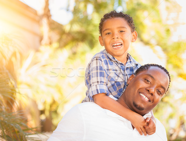 Mixed Race Son and African American Father Playing Outdoors Toge Stock photo © feverpitch