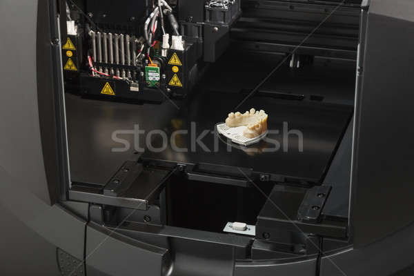 3D Printer With Finished 3D Printed Dental Implant Bridge Stock photo © feverpitch