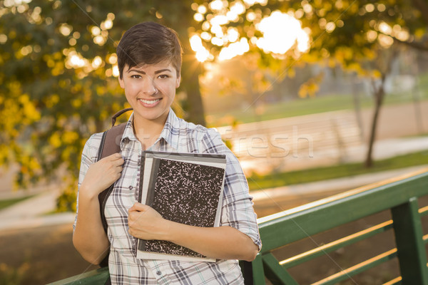 Portrait of a Pretty Mixed Race Female Student Holding Books Stock photo © feverpitch