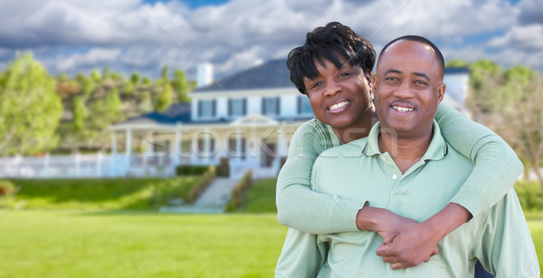 Happy African American Couple In Front of Beautiful House. Stock photo © feverpitch