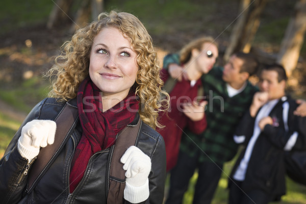 Pretty Young Teen Girl with Boys Behind Admiring Her Stock photo © feverpitch