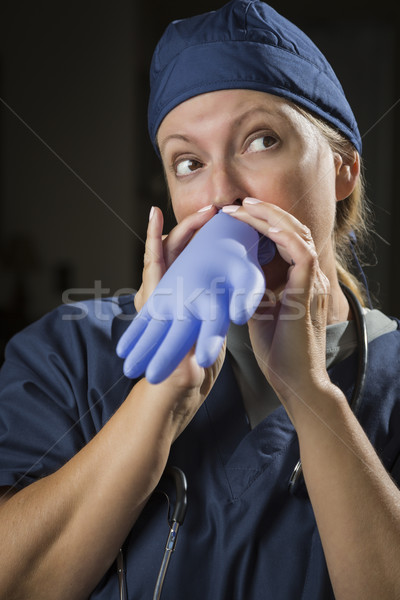 Playful Doctor or Nurse Inflating Surgical Glove Stock photo © feverpitch