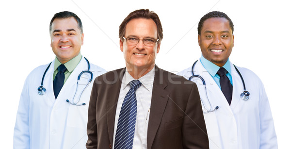 Two Mixed Race Doctors Behind Businessman  Isolated on White Stock photo © feverpitch