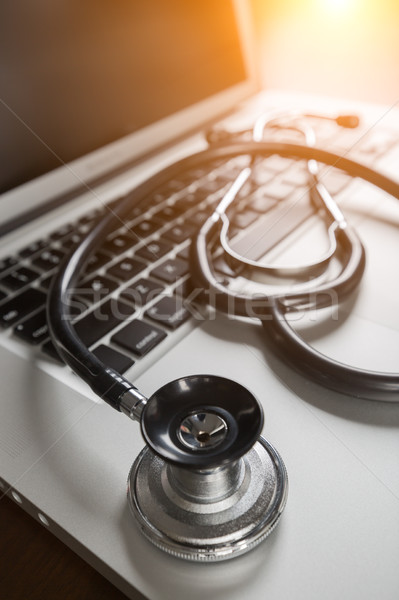Medical Stethoscope Resting on Laptop Computer Keyboard. Stock photo © feverpitch
