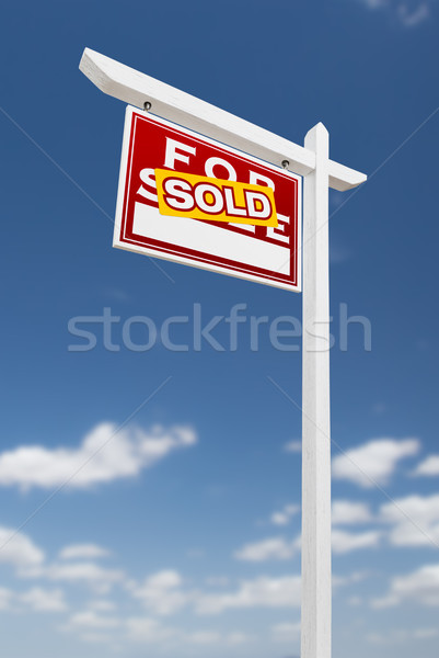Left Facing Sold For Sale Real Estate Sign on a Blue Sky with Cl Stock photo © feverpitch