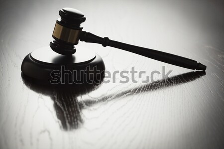 Dramatic Gavel Silhouette on Reflective Wood Stock photo © feverpitch
