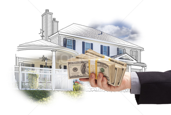 Hand Holding Thousands In Cash Over House Drawing and Photo Stock photo © feverpitch