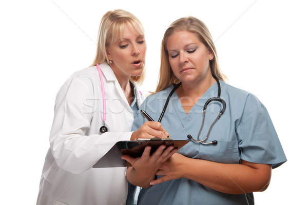 Stock photo: Two Doctors or Nurses Looking of File on Clipboard