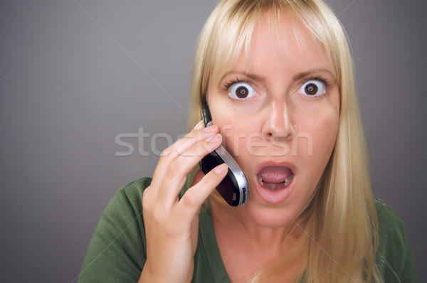 Stunned Blond Woman Using Cell Phone Stock photo © feverpitch