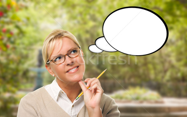 Thoughtful Young Woman with Pencil and Blank Thought Bubble. Stock photo © feverpitch